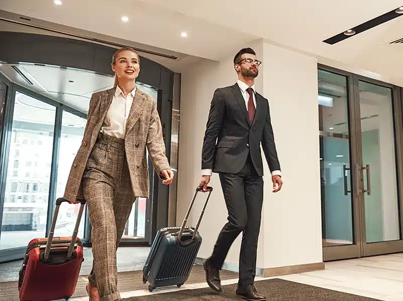 people walking into hotel happy